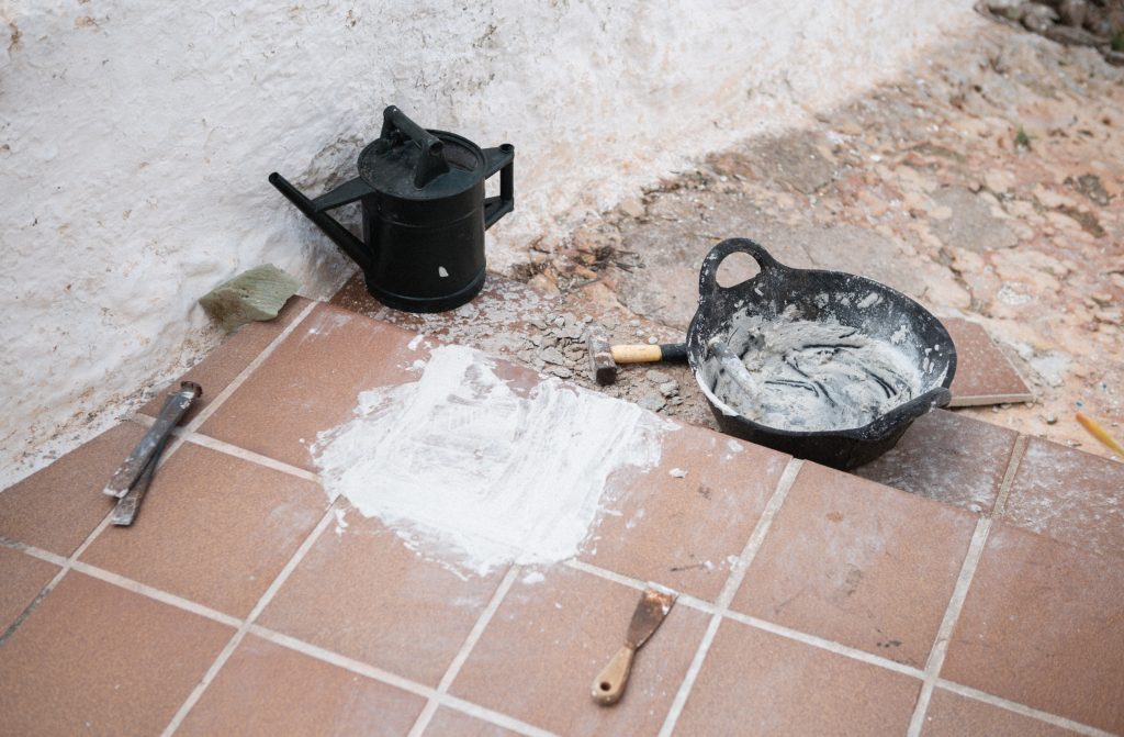 Construction tools and materials on tiled floor, Ciutadella de Menorca, Balearic Islands. Outils de construction et matériaux sur sol carrelé, Ciutadella de Menorca, îles Baléares.